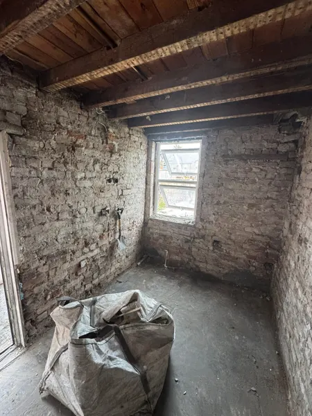 Bagged material in the stripped room